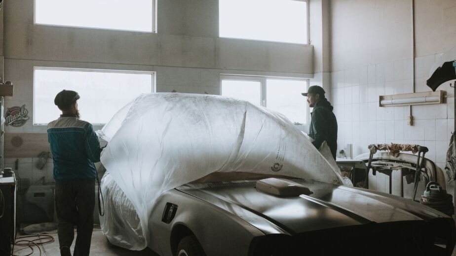 mechanic repairing car body garage workshop