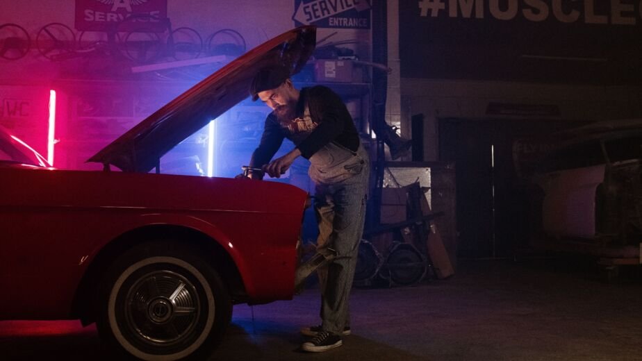 mechanic working car garage dark